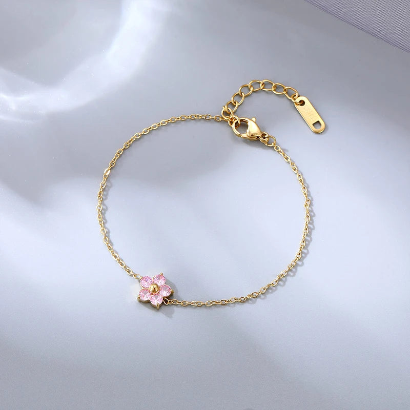 Pulsera de acero inoxidable con circonitas cúbicas de colores y flores chapadas en oro de 16 quilates